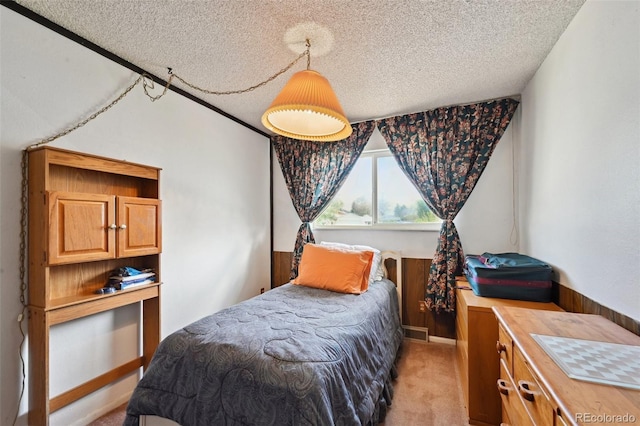 bedroom with light carpet, a textured ceiling, and visible vents