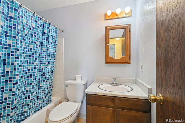 bathroom featuring vanity, shower / bath combo with shower curtain, and toilet