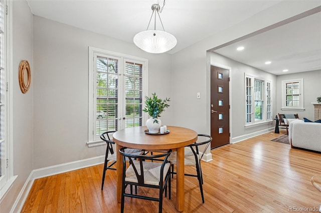 dining room featuring light wood-style floors, baseboards, french doors, and recessed lighting