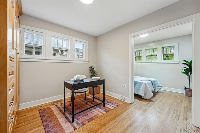 office featuring baseboards and light wood-style flooring