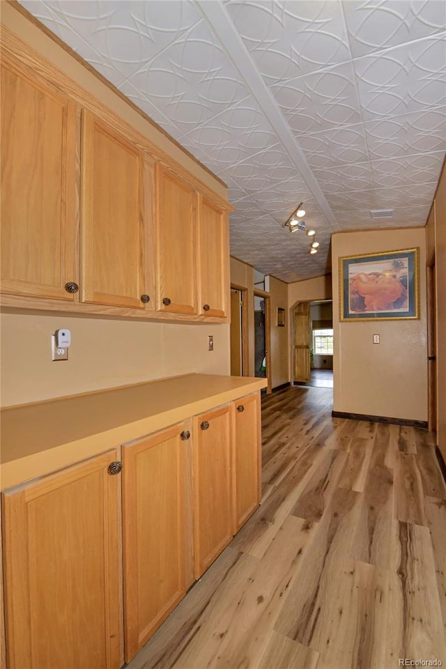 kitchen featuring light hardwood / wood-style flooring and light brown cabinets