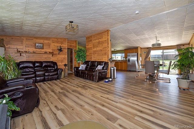 living room with wood walls and hardwood / wood-style flooring