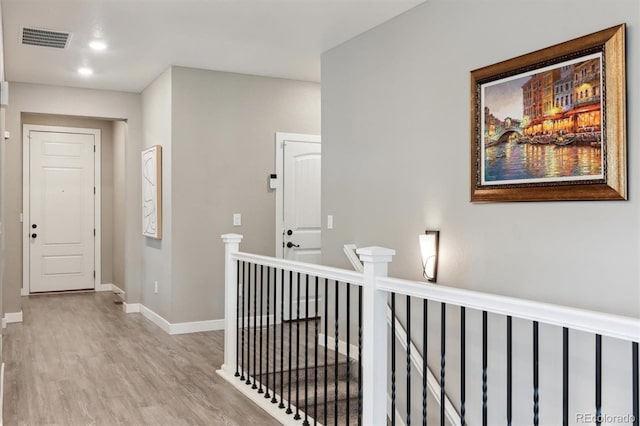 4077 Forever Cir, Castle Rock, CO 80109 - hall with visible vents, light wood-style flooring, baseboards, and an upstairs landing