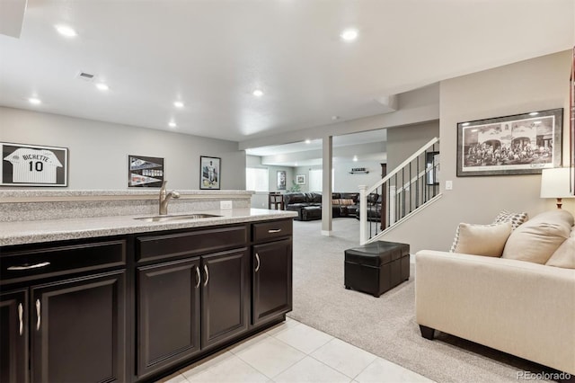 4077 Forever Cir, Castle Rock, CO 80109 - kitchen featuring visible vents, a sink, light tile patterned floors, open floor plan, and light carpet