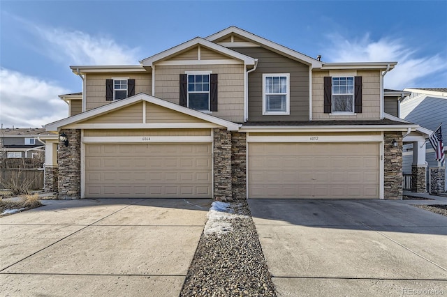 view of front of property with a garage, stone siding, and driveway