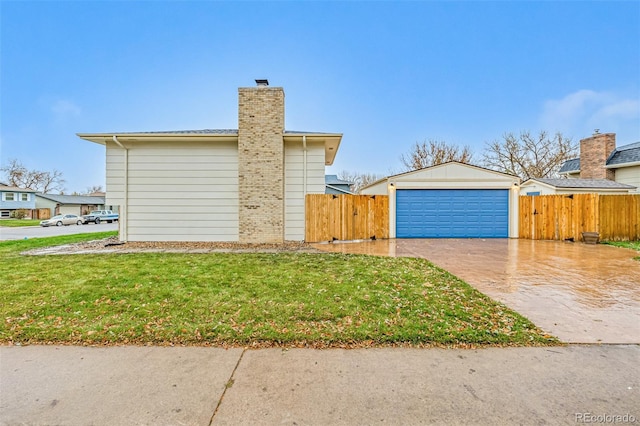 view of side of property featuring a yard and a garage