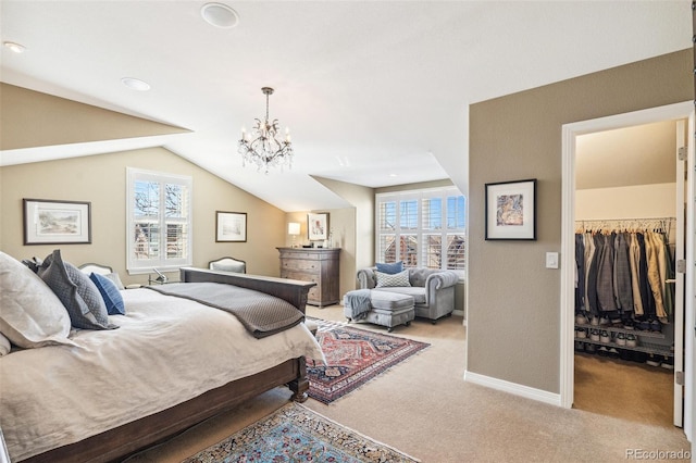 bedroom featuring lofted ceiling, light colored carpet, a spacious closet, a chandelier, and baseboards