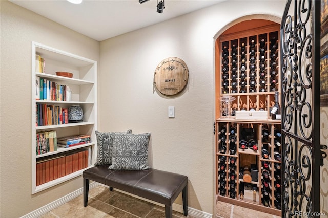 wine cellar featuring built in features and baseboards