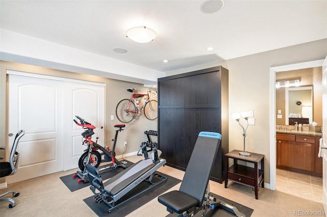 workout area with baseboards, recessed lighting, and light colored carpet