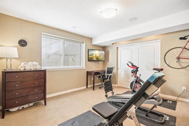 exercise room with carpet floors, visible vents, and baseboards