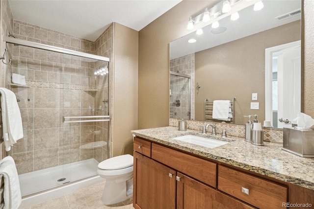 full bathroom with toilet, a stall shower, vanity, and visible vents