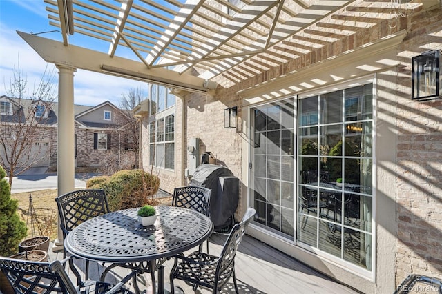 wooden deck featuring outdoor dining area, a grill, and a pergola