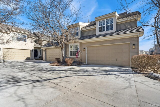 traditional-style house with concrete driveway