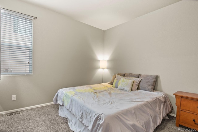 bedroom with visible vents, carpet floors, and baseboards