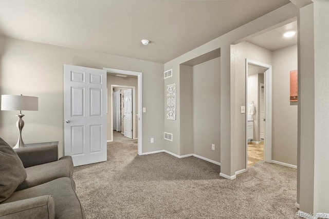 carpeted living room with visible vents and baseboards