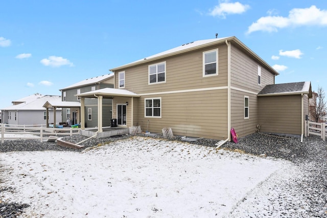 rear view of house with a patio area and fence