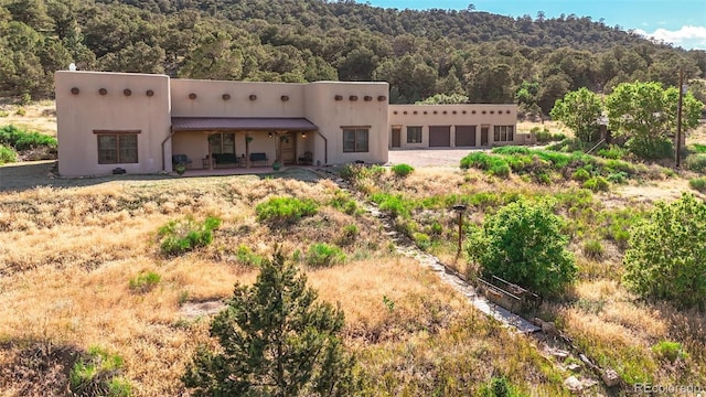 rear view of property with a garage