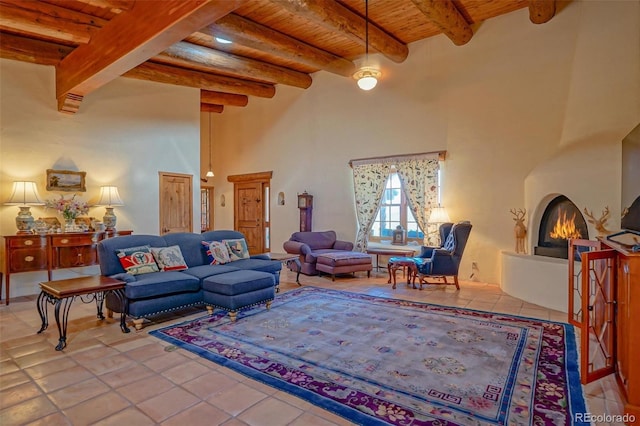 living room featuring wood ceiling, a large fireplace, tile patterned flooring, and beamed ceiling