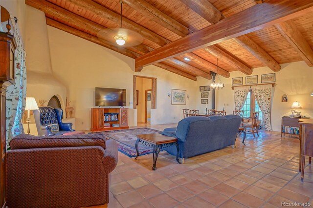 tiled living room featuring an inviting chandelier, beamed ceiling, and wooden ceiling