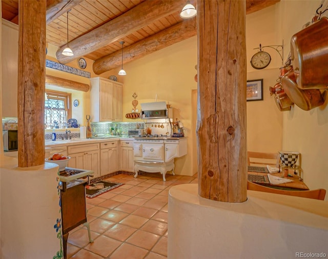 kitchen with pendant lighting, light brown cabinetry, light tile patterned floors, and wooden ceiling