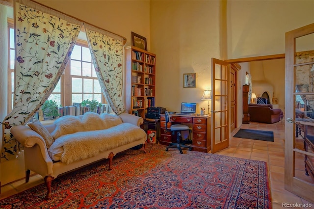 tiled bedroom with french doors and a towering ceiling