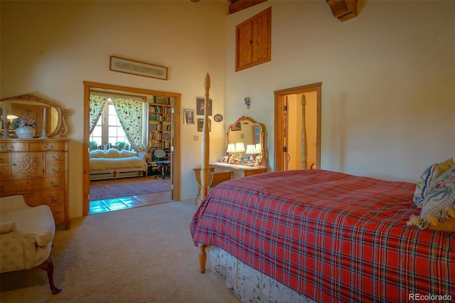 bedroom with light carpet and a high ceiling