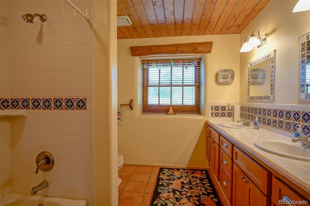 full bathroom featuring tiled shower / bath combo, vanity, wood ceiling, toilet, and tile patterned floors