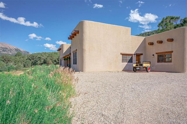 exterior space with a patio and a mountain view