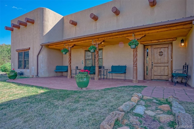 exterior space featuring a patio area and a lawn