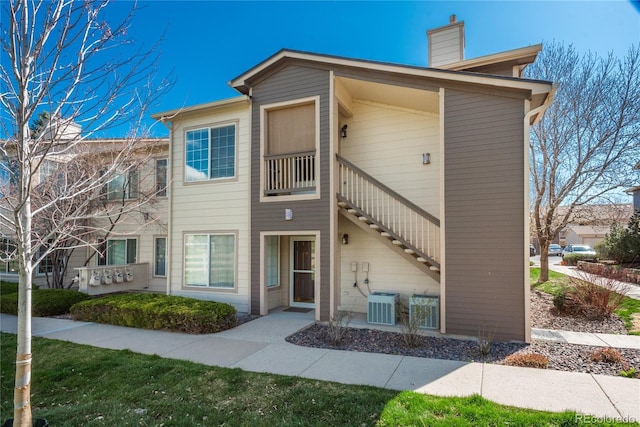 8775 W Berry Ave Unit 101, Littleton, CO 80123 - multi unit property featuring a chimney, central AC unit, and stairs