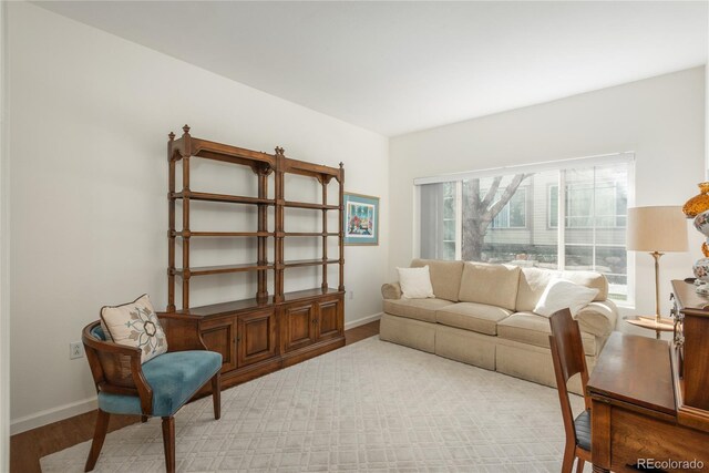 8775 W Berry Ave Unit 101, Littleton, CO 80123 - living room featuring baseboards and light wood-style floors