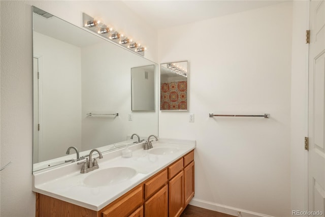 8775 W Berry Ave Unit 101, Littleton, CO 80123 - bathroom featuring double vanity, wood finished floors, and a sink