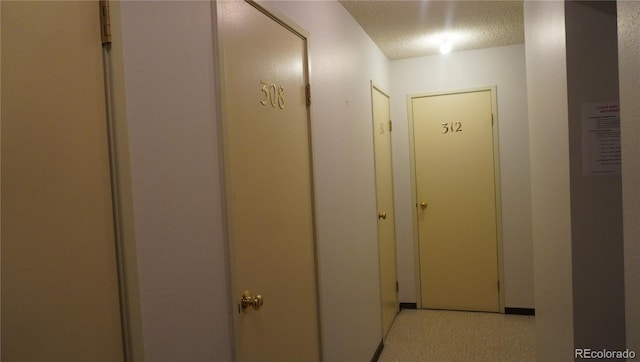 corridor featuring a textured ceiling