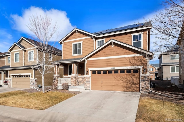 craftsman inspired home with a garage, a front yard, solar panels, and a porch