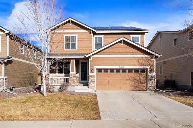 craftsman inspired home featuring a porch, a garage, solar panels, a front yard, and cooling unit