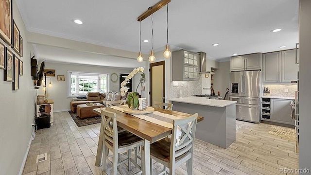 12020 W Alabama Pl, Lakewood, CO 80228 - dining space featuring light wood finished floors, recessed lighting, and crown molding