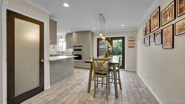 12020 W Alabama Pl, Lakewood, CO 80228 - dining area featuring light wood-style flooring, crown molding, and recessed lighting