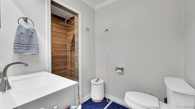 12020 W Alabama Pl, Lakewood, CO 80228 - bathroom featuring crown molding, vanity, and a tile shower
