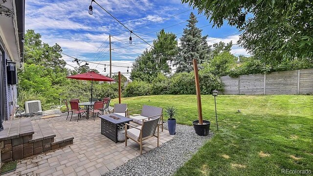 12020 W Alabama Pl, Lakewood, CO 80228 - fenced backyard featuring a patio area, outdoor dining area, and an outdoor fire pit