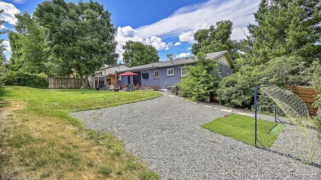 12020 W Alabama Pl, Lakewood, CO 80228 - back of house featuring a patio area and a storage unit