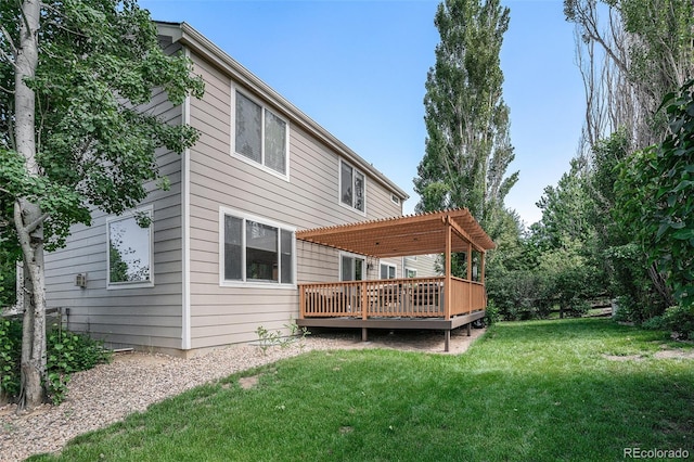 1201 102nd Ave, Greeley, CO 80634 - rear view of house with a pergola, a wooden deck, and a lawn