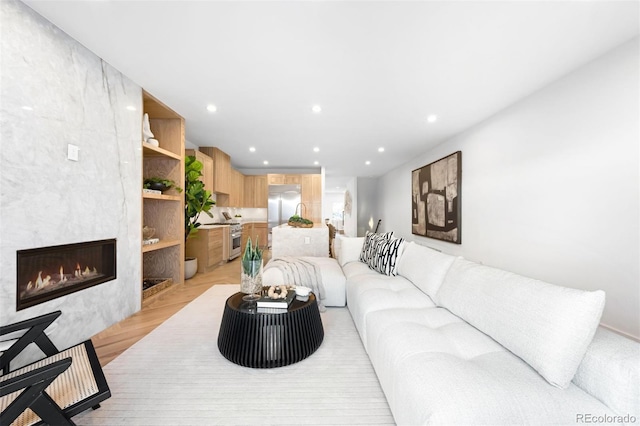 living room with recessed lighting and a fireplace