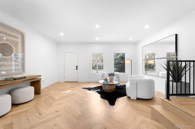 living area featuring recessed lighting and baseboards