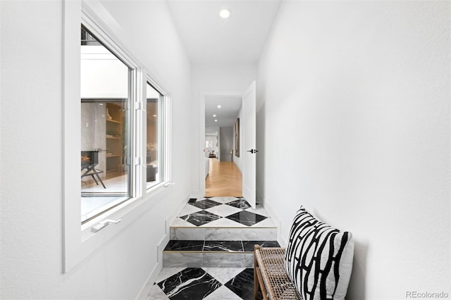 hallway featuring recessed lighting, marble finish floor, and baseboards