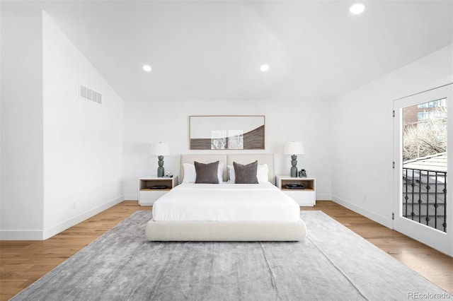 bedroom with recessed lighting, visible vents, baseboards, and wood finished floors