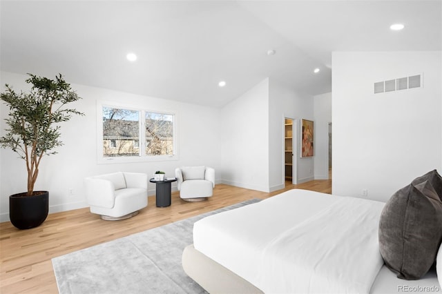 bedroom featuring light wood-type flooring, visible vents, lofted ceiling, and recessed lighting