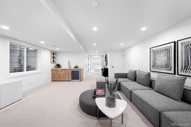 living room featuring baseboards, beverage cooler, light colored carpet, a dry bar, and recessed lighting