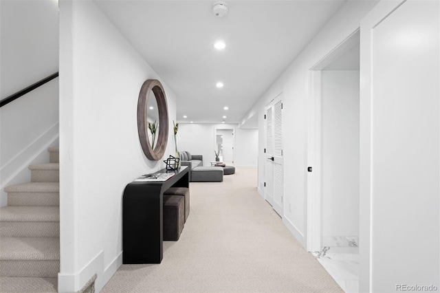 hall featuring recessed lighting, baseboards, and stairs