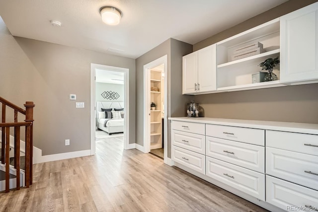 kitchen with white cabinets and light hardwood / wood-style flooring