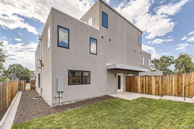 rear view of property with a patio area and a yard